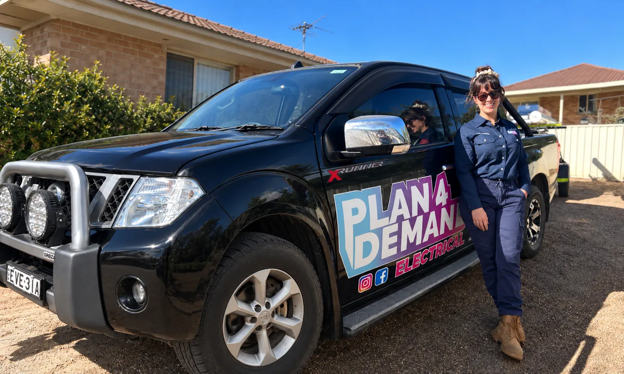 Miranda from Plan 4 Demand Electrical standing beside her branded work ute